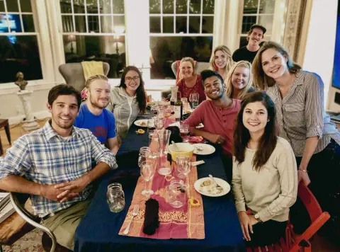 Rafat and friends around a candlelit table at one of his SF dinner parties
