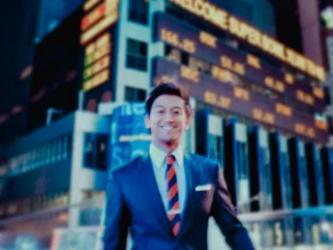 Rafat in a suit in Times Square, New York, during his Wall Street years