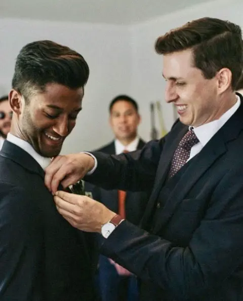 Rafat as a groomsman, having his boutonnière adjusted at his friend Paul's wedding